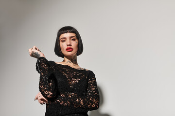 A striking young woman showcases her style with confident allure.