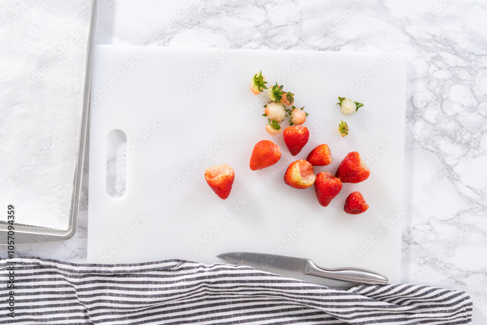 Wall mural Cutting Fresh Strawberries on a White Cutting Board