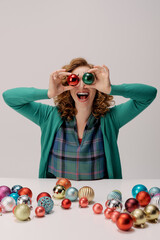 A cheerful young woman is having fun posing cheerfully, cheerful decorations scattered around her.