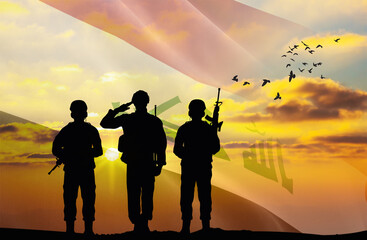 Silhouettes of soldiers with a background of the Iraq flag and a sunset or sunrise. Concept of...