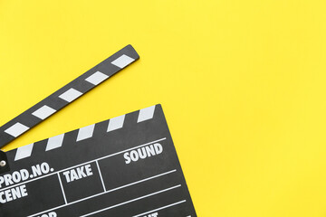 Naklejka premium Movie clapper on yellow background