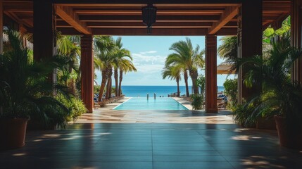 Fototapeta premium Elegant hotel entrance showcasing a picturesque pool and breathtaking ocean view in the background