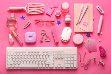 Composition with female accessories, cosmetics, credit cards and gadgets on pink background