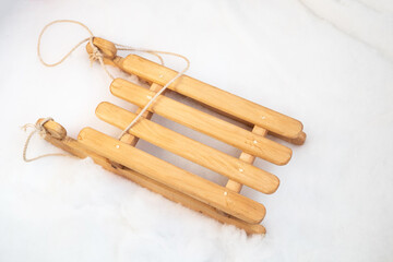 Wooden sled resting on a snowy surface, ready for winter fun and adventure