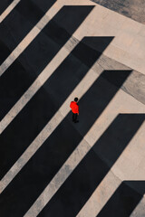 Obraz premium Solitary Figure in Bold Urban Geometry with Dramatic Shadow Play