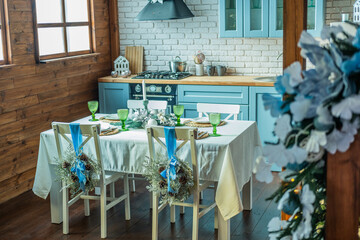 Cozy dining area with blue accents and decorative chairs in rustic kitchen