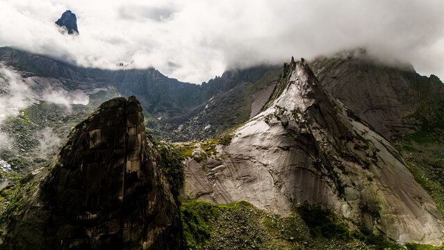 the rocks in the form of a parabola are shrouded in white clouds
