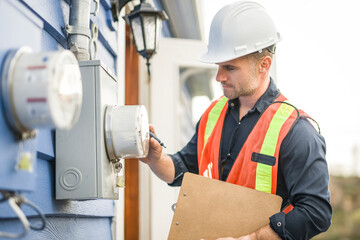 man with hard hat standing in front of a electric panel