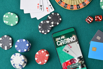 Online game app on smartphone on game table with objects