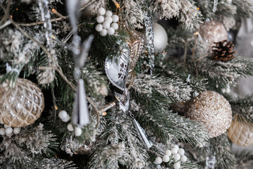 Decoratively adorned Christmas tree with frosty ornaments and lights