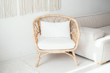 Cozy rattan chair with white cushions in a modern living room setting