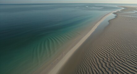 Aerial of shallow ocean waters with sand ripples