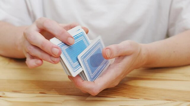 female hands shuffle a deck of playing cards. gambling. A board game for spending leisure time with friends and family.