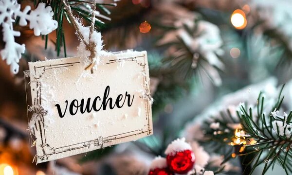 voucher paper tag hanging on christmas tree in winter
