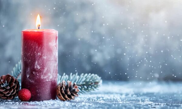 red christmas candle on snowy background