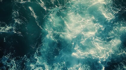 Ocean scene with sunlight dancing on blue-green waves, capturing the vibrant beauty of the coast