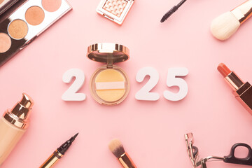 2025 Beauty cosmetic makeup products trends concept. Top view of 2025 white number with powder,...