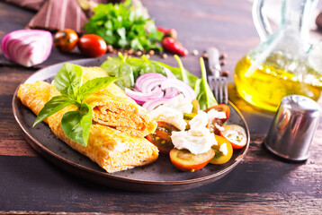 omelette with cherry tomatoes, parsley. and grated cheese
