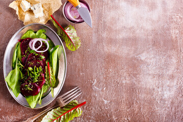 salad from boiled beet on dark background.