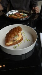 Croissant or sandwich with salted filling. Croissants with trout, meat bacon, vegetables and fruits