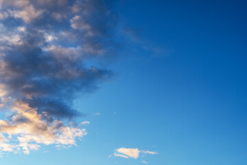 Sky background. Blue evening sunset sky with clouds.