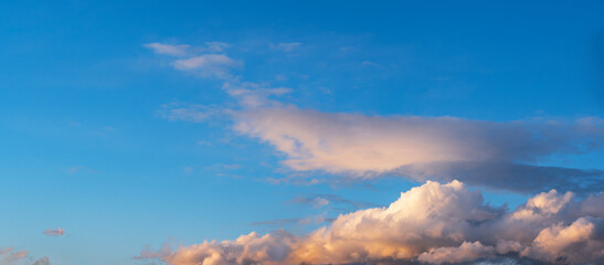 Sky background. Blue evening sunset sky with clouds.