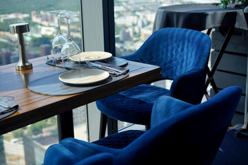 The interior of restaurant on top floors of skyscraper. View overlooking town.