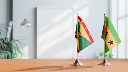 FLAGS OF GRENADA AND SAO TOME ON TABLE