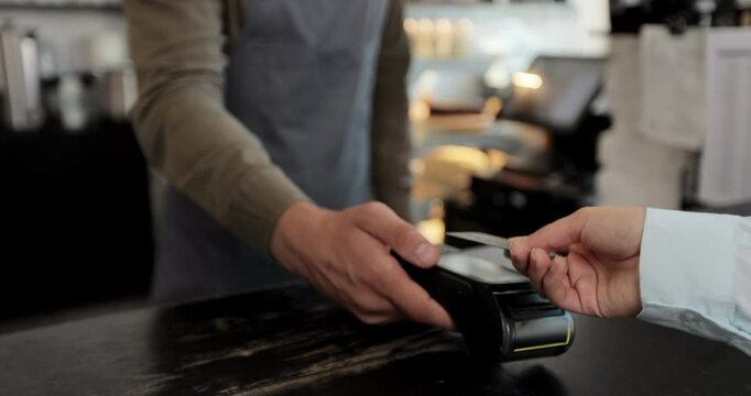 Close up customer pay using credit card contactless payment spending money in cafe with digital transaction service.