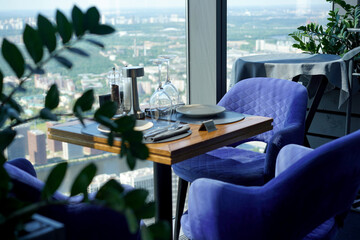 The interior of restaurant on top floors of skyscraper. View overlooking town.