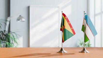 FLAGS OF GRENADA AND UZBEKISTAN ON TABLE