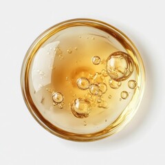 Golden Liquid Oil with Bubbles in a Round Dish