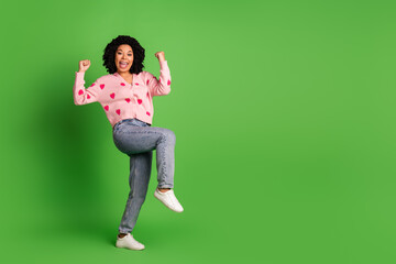 Full length photo of lovely young lady raise fists winning dressed strawberry print pink garment isolated on green color background