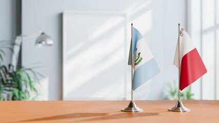 FLAGS OF GUATEMALA AND MALTA ON TABLE