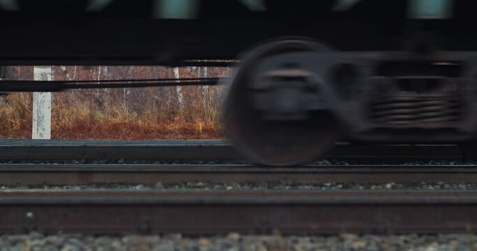 Cargo train wheels. Close-up of tracks and wheels of a freight train. Heavy long-haul trucking industry. Delivery of cargo and goods all over the world.