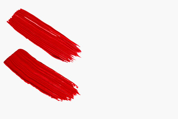Composition of red lipstick smears or red textured cosmetic on a light background. Beauty product,...