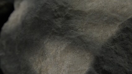 Soft shadowed surface of a weathered grey rock