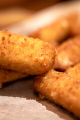 Close up of appetizing fried mozzarella sticks on paper towel