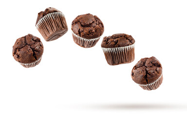 Chocolate chip muffins flying, isolated on white background.