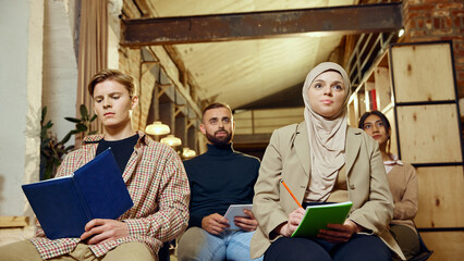 Group of business people listening attentively during seminar in modern workspace. Corporate learning in dynamic environment. Concept of dei in business, teamwork, education, seminar