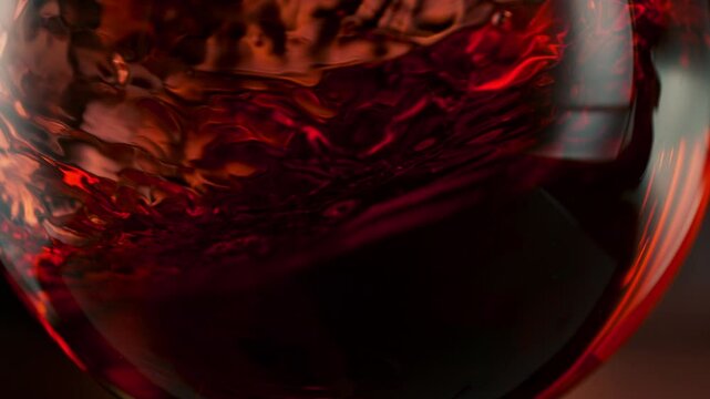 Super Slow Motion Detail Shot of Spinning Red Wine in Glass at 1000fps.