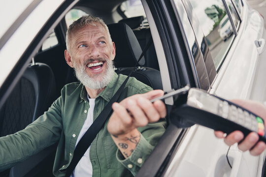 Photo of attractive funny retired guy wear khaki shirt riding automobile paying cafe to go outdoors urban city street - Powered by Adobe