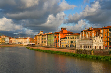 Fototapeta premium Summer sunset landscape of Pisa old city and the embankment of Arno river, Italy, Europe 