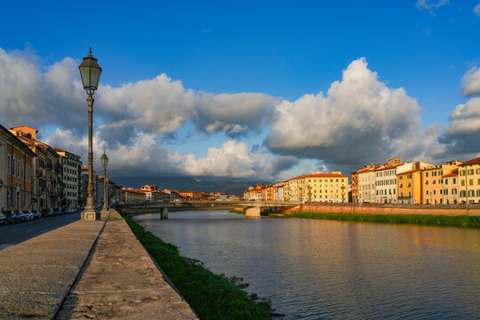 Summer sunset  landscape of Pisa old city and the embankment of Arno river, Italy, Europe