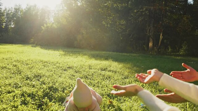  baby takes the first steps unsuccessfully falls in nature