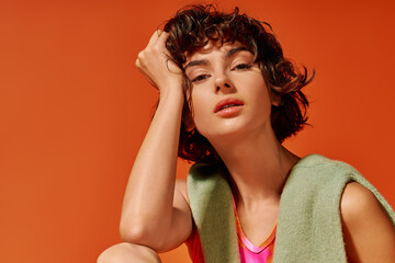 The young woman gazes thoughtfully, showcasing her expressive emotions with a colorful backdrop.