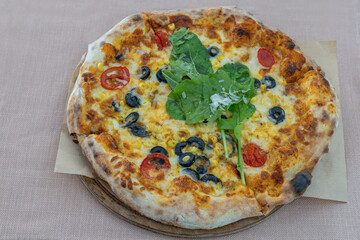 Four seasons pizza. Tomatoes, grated mozzarella, tomato sauce, corn kernels, black olive slices, arugula.