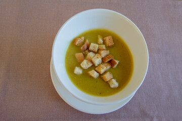 Lentil soup garnished with crispy bread.