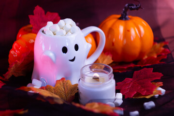 Orange pumpkins in autumn leaves. Festive Halloween mood. Black and pink background. 