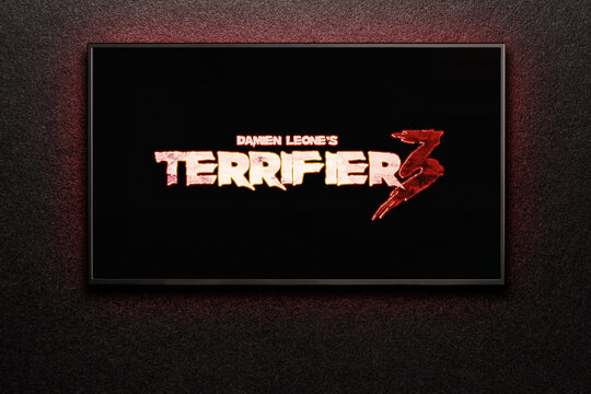Terrifier 3 trailer or movie on TV screen. TV on black textured wall. Astana, Kazakhstan - October 30, 2024.